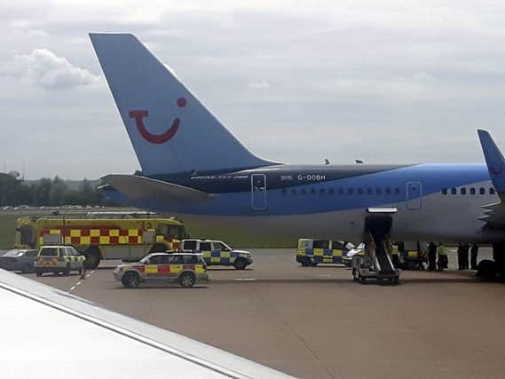 Passengers from adjacent planes show a large number of police vehicles. Picture: SWNS