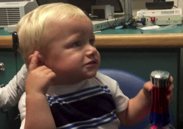 Kanon Newsome hears through his cochlear implant for the first time. Picture: SWNS