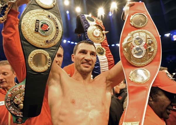 Wladimir Klitschko with his belts after beating David Haye.  Picture: AP.