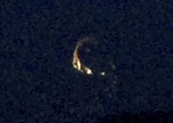 This mysterious 'UFO' has been captured on video circling over a remote country town for several minutes. Picture: SWNS