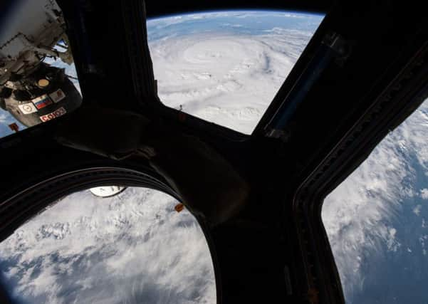 This NASA image from August 25, 2017, taken by NASA astronaut Jack Fischer shows Hurricane Harvey (top) from the cupola module aboard the International Space Station. Picture: NASA