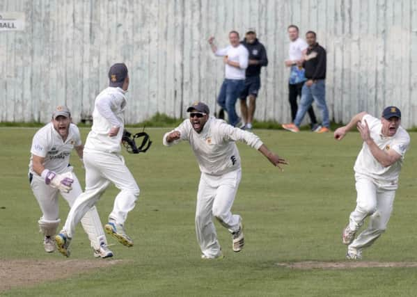 Prestwicks Fraser McDonald, Tom Fleet (back to camera), Shazad Rafiq and Ross Paterson celebrate the wicket of Heriots Mark Watt.  Photograph: Donald MacLeod