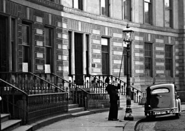 A "leerie" at work in Park Circus, Glasgow, in 1955. Â© CSG CIC Glasgow Museums Collection.