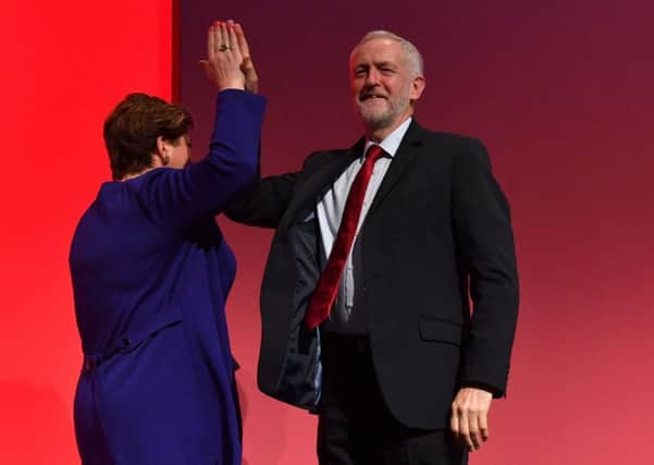 Jeremy Corbyn high-fives shadow foreign Secretary Emily Thornberry after her speech. Picture: Getty