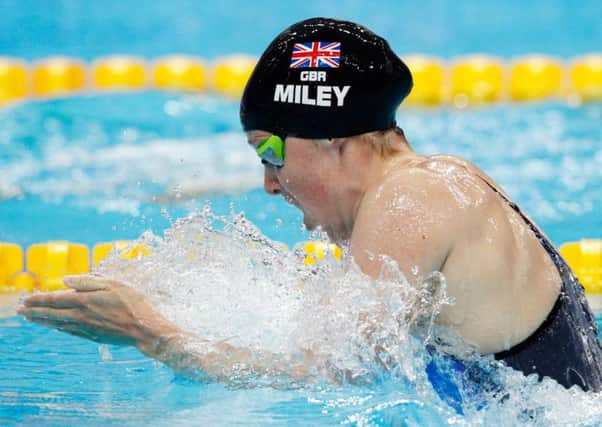 Double gold: Hannah Miley  in action in the pool earlier this year, top  celebrates winning in Delhi, above, and Glasgow, far left.
Photographs: Getty Images