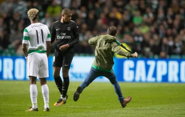 Supporter John Hatton entered the pitch and aimed a kick at PSG star Kylian Mbappe. Picture: Getty