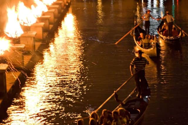 Gondolas on a canal during the Waterfire festival. Photograph: 
Getty/iStock