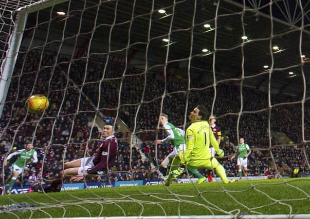 Hibs striker Oli Shaw, centre, watches his seventh-minute effort bounce down off the bar and over the line but assistant referee Sean Carr did not give the goal. Picture: Paul Devlin/SNS