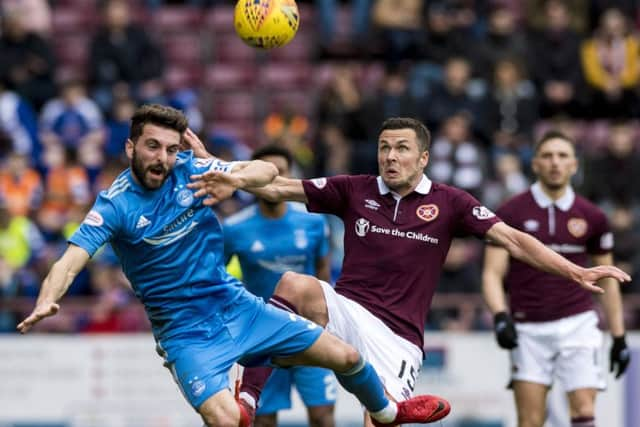 Graeme Shinnie challenges Hearts Don Cowie during the home side's 2-0 victory at Tynecastle. Picture: SNS.