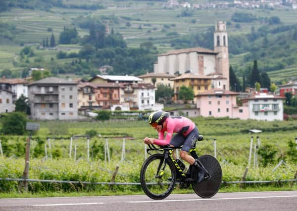 Britains Simon Yates out on the road during the time trial and, left, Rohan Dennis celebrates his win. Picture: AFP/Getty.