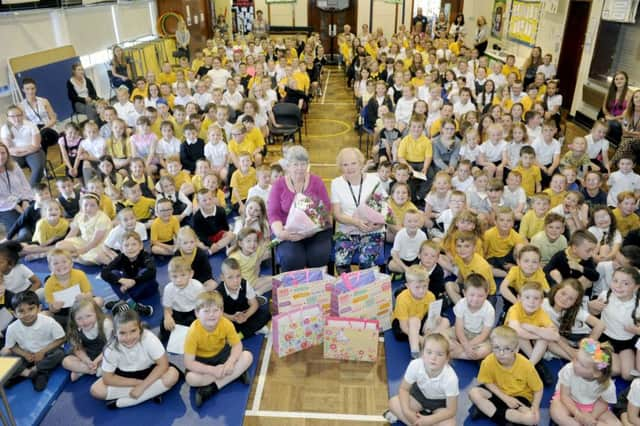 Retiring principal teacher Fiona Downie and support for learning assistance Janet Anderson. Also leaving the school at the end of term is head teacher Paul Fleming who is taking up a post with Education Scotland. Seated is Janet Anderson and Fiona Downie with pupils.