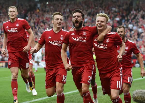 Gary Mackay-Steven (right) celebrates with his team-mates after opening the scoring. Picture: SNS