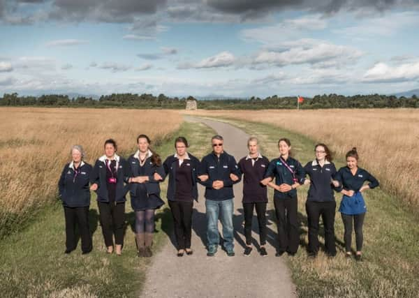 National Trust for Scotland staff link arms at Culloden as the organisation calls for greater protection of historic sites in the the planning system. Picture: Contributed.