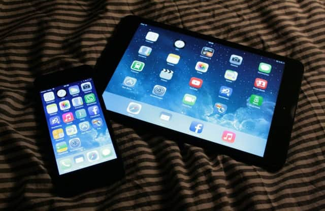 A shopper uses a tablet as he queues outside Apple's Regent Street store in 2017 waiting for the store to open on the day of the launch of the Apple iPhone X.
 Picture: AFP/Getty