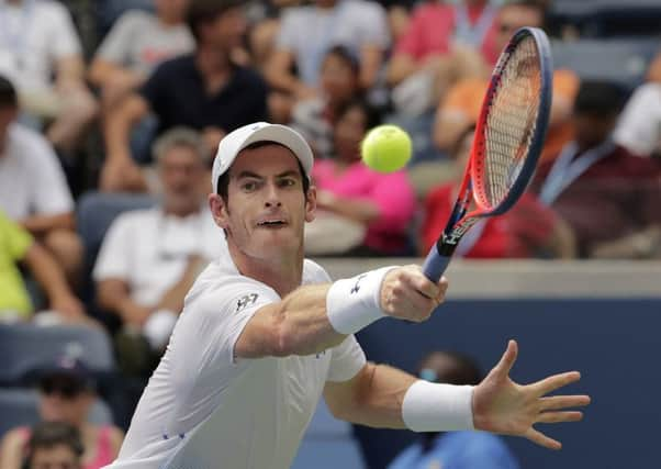 Andy Murray stretches for a backhand (main picture) during his 6-7, 6-3, 7-5, 6-3 victory against James Duckworth.