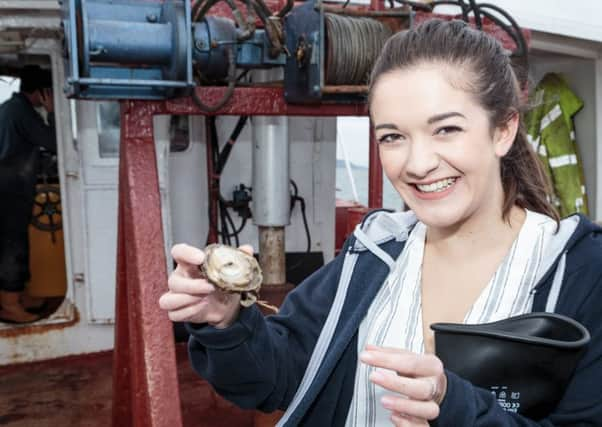 Festival coordinator Allana Hardie tries one of the first oysters of the season.