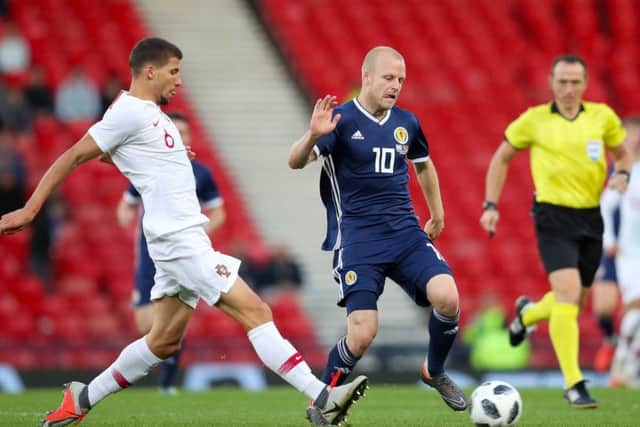 Steven Naismith, scorer of Scotland's consolation goal, evades Portugals Ruben Dias. Picture: PA.