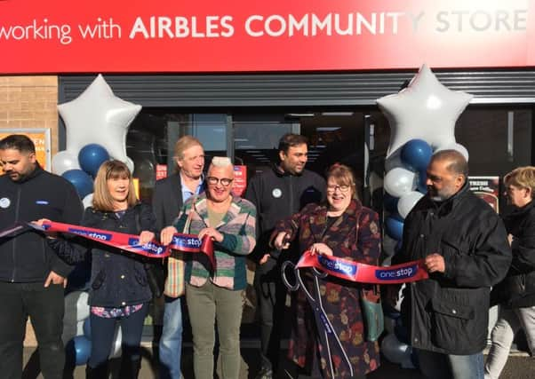 Community representatives join the Hussain family for the store opening