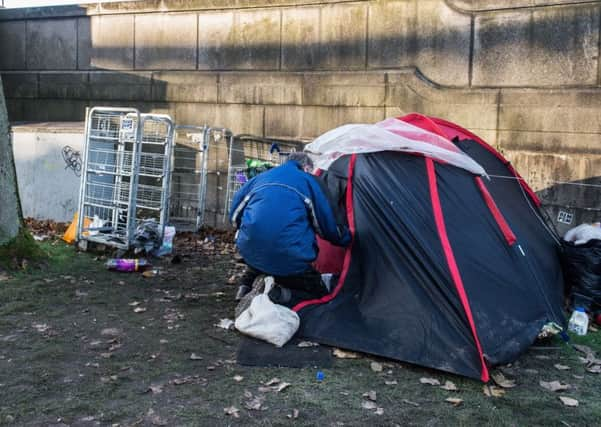 GLASGOW. City Centre. Stock shot of the homeless on the streets of Glasgow. A homeless man and his partner sleep in this tent with their dog down at the river Clyde.