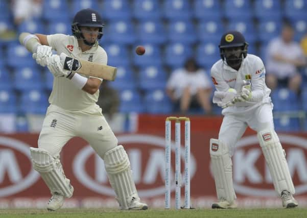 England's Sam Curran plays a shot as Sri Lanka's Niroshan Dickwella watches during the first day of the second Test in Kandy. Picture: Eranga Jayawardena/AP