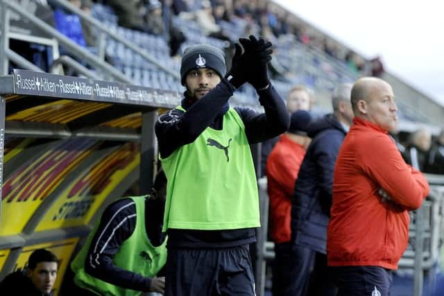 Falkirk striker Dennon Lewis applauds the home supporters for their anti-racism display