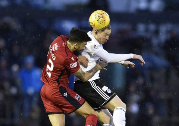 Ross County's Stelios Demetriou competes with Andy Geggan. Pic: SNS/Rob Casey