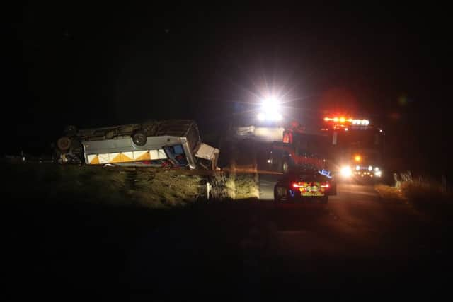 The scene on the A6089, between Carfraemill and Gordon in Scotland, where one man died and 23 people were taken to hospital after a private minibus overturned. Picture: Andrew Milligan/PA Wire