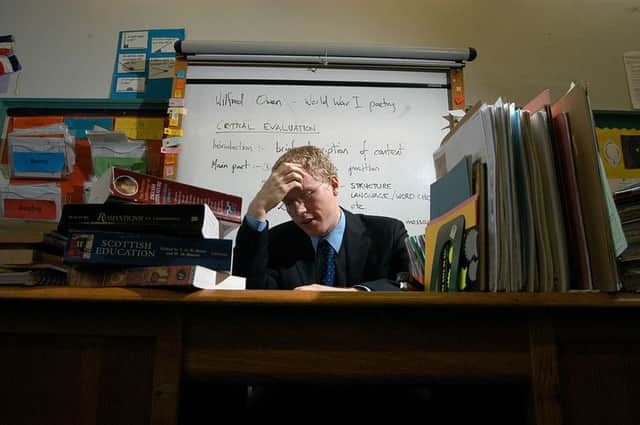 The number of heads working in more than one school is rising. Posed by models in set up classroom. 28/02/03