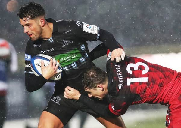 Adam Hastings, seen here holding off Lyons 
Pierre-Louis Barassi last month, is one of four changes to the Glasgow team for the Champions Cup showdown with Saracens. Picture: Ian MacNicol/Getty Images