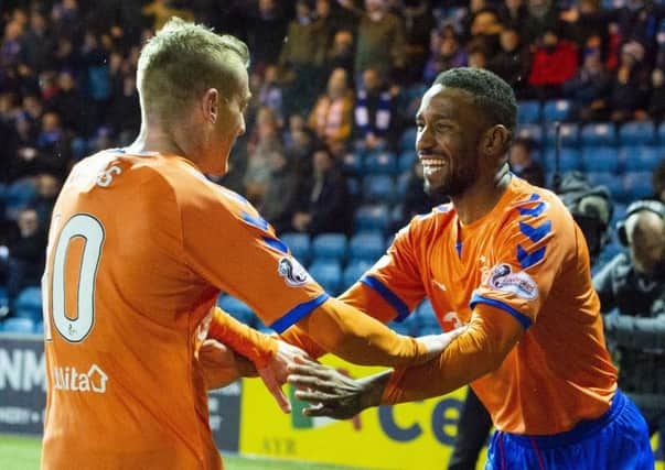 Jermain Defoe celebrates with Steven Davis (left) after he scores on his Rangers debut. Picture: SNS