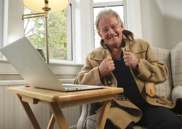 Terry Christie at home with his trademark duffle coat. Picture: Toby Williams