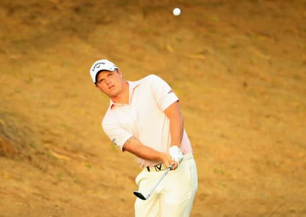 Callum Shinkwin plays his third shot on the third during day two of the Omega Dubai Desert Classic. Picture: Andrew Redington/Getty