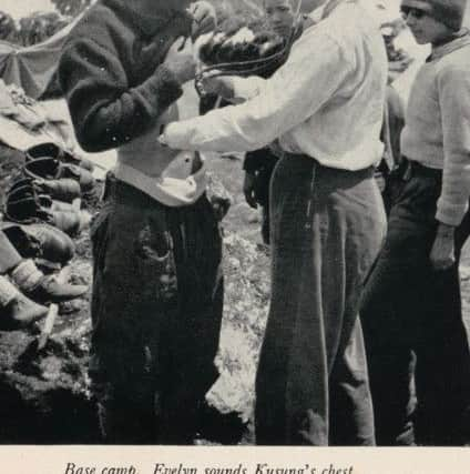 Evelyn McNicol, who was part of the first all-female expedition to the Himalayas in 1955, checks the health of a sherpa. PIC: National Library of Scotland.