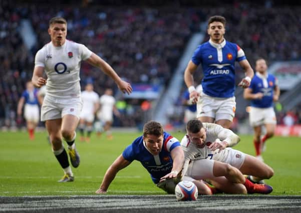 Englands hat-trick hero Jonny May battles Antoine Dupont for possesion during the home sides thumping victory. Picture: Getty.