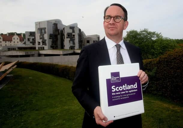 Andrew Wilson with a copy of the Sustainable Growth Commission report published last year. Picture: PA