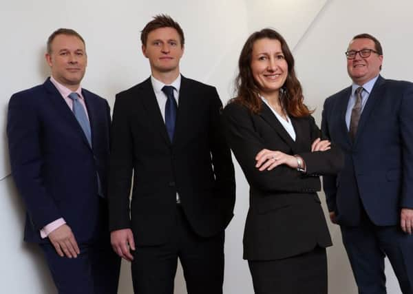 Pictured are chair Bruce Farquhar, left, and managing partner Murray McCall, right, with Gary Burton and Victoria Simpson Picture: Stewart Attwood.