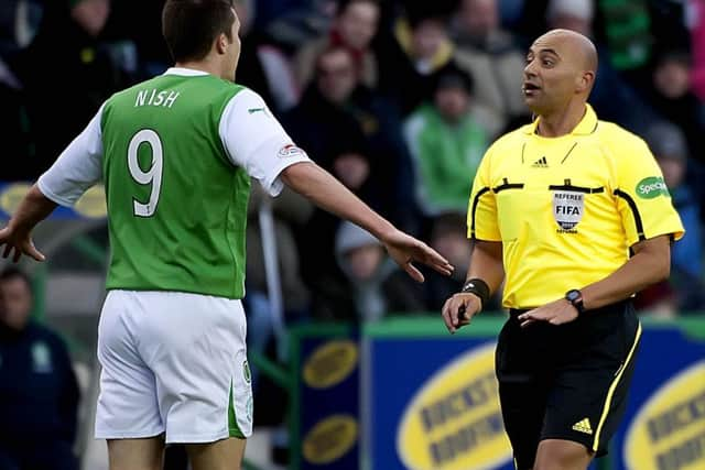 Maltese referee Christian Lautier has words with Hibs striker Colin Nish in November 2010. Picture: SNS Group