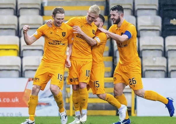 Livingston's Chris Erskine celebrates his opener with Craig Sibbald. Pic: SNS/Roddy Scott