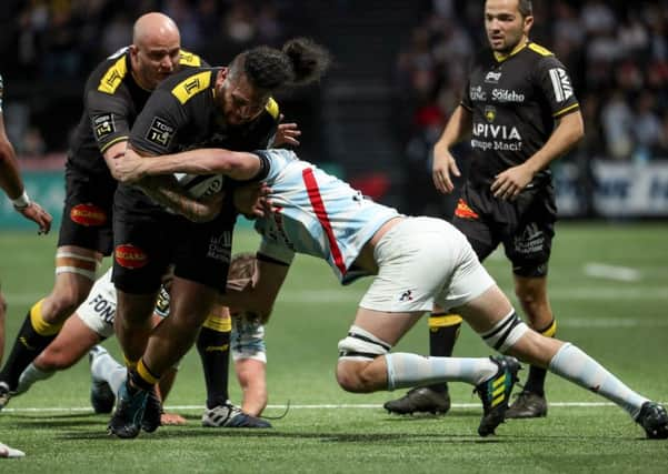 La Rochelle's French prop Vincent Pelo (C) fights for the ball with Finn Russell. Pic: Kenzo Tribouillard/AFP/Getty