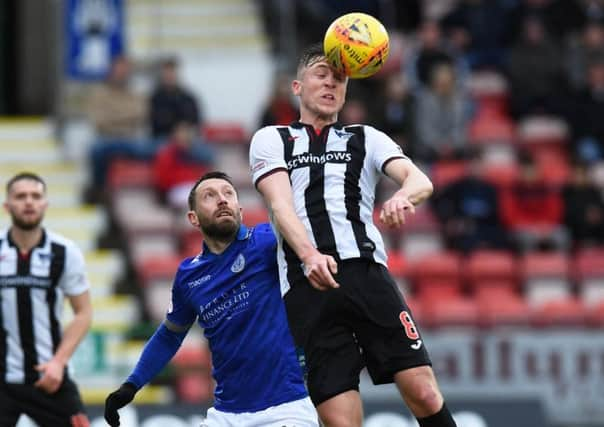 Dunfermlines Tom Beadling challenges Stephen Dobbie. Photograph: Ross MacDonald/SNS Group