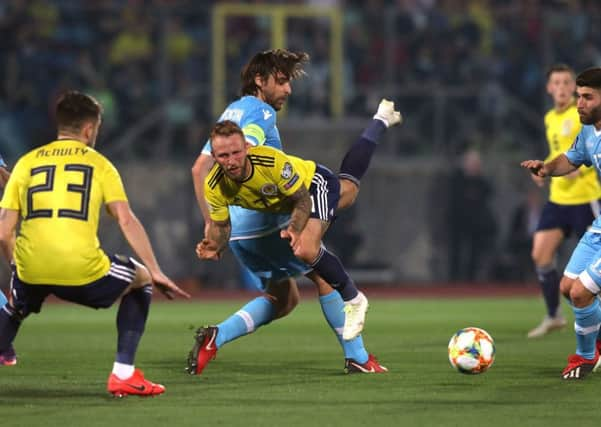 Johnny Russell challenges the San Marino defence as Marc McNulty looks on. Picture: PA.