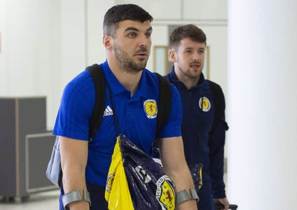 Callum Paterson comes home on crutches from Scotland duty. Picture: SNS