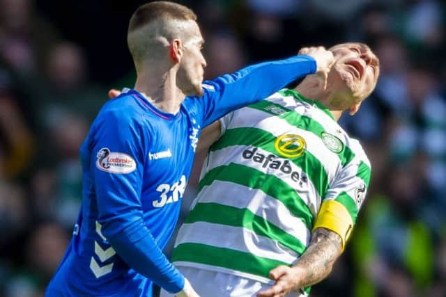 Ryan Kent, left, strikes out at Celtic captain Scott Brown. Picture: SNS