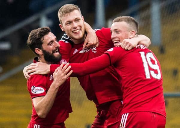 Sam Cosgrove, centre, celebrates his second goal with Aberdeen captain Graeme Shinnie and Lewis Ferguson. Picture: Ross Parker/SNS