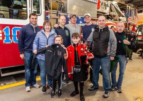 Piper Josh Bruce with his personalised jacket from the New York Fire Department. Picture: New York Tartan Week/PA