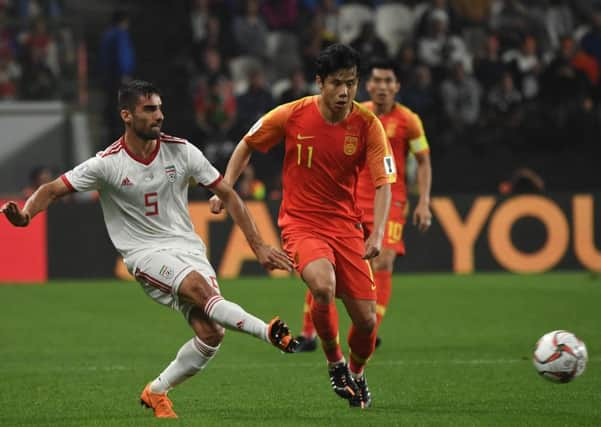 Milad Mohammadi plays the ball as Hao Junmin of China keeps tabs on the Iran defender during the 2019 Asian Cup. Picture: Getty Images