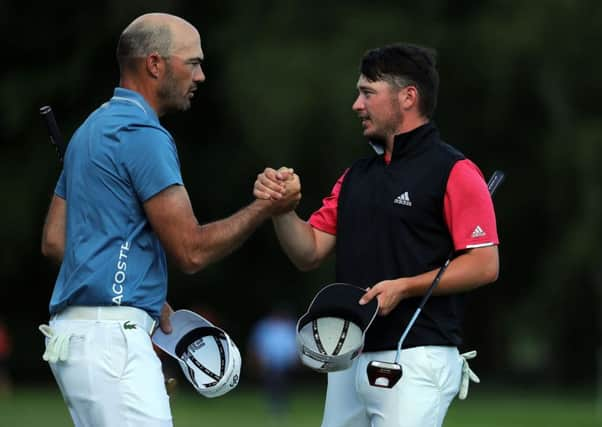 Ewen Ferguson, right, shakes hands with Gregory Havret. Picture: Getty.