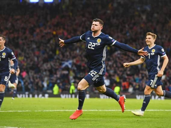 Oli Burke wheels away after netting the winner for Scotland