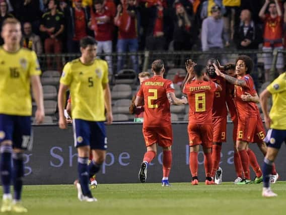 Brussels pouts: Belgium celebrate Romelu Lukaku's opener as Scott McTominay and Scott McKenna look dejected