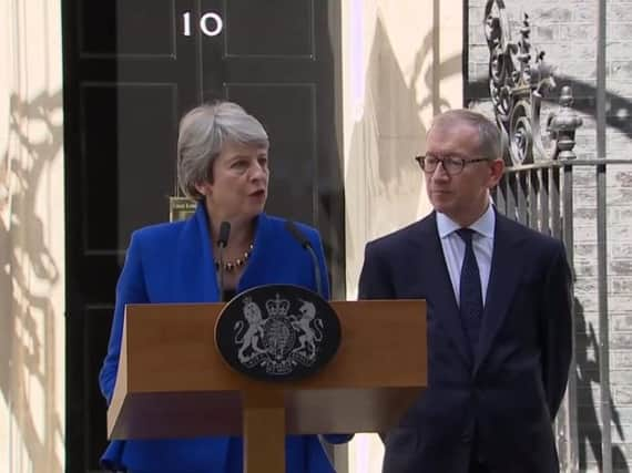 Theresa May and her husband Philip appeared in Downing Street before going to Buckingham Palace